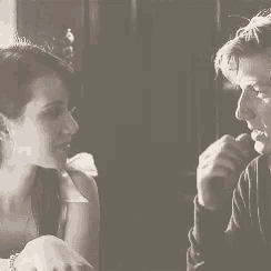 a man and a woman are looking at each other