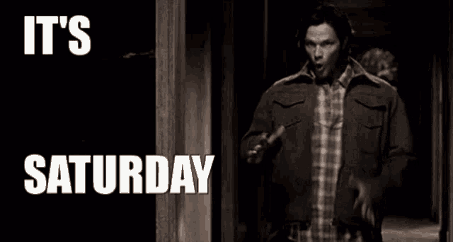 a man in a jacket is walking down a hallway with the words `` it 's saturday '' .