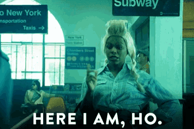 a woman in a wig is standing in front of a sign that says subway