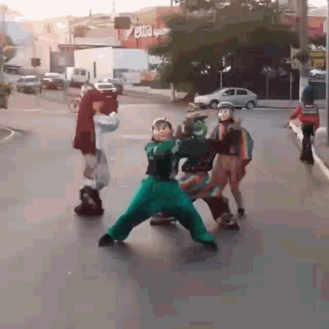 a group of children dressed up in costumes are playing on a street .