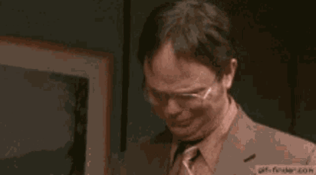 a man in a suit and tie is crying while saying thank you .
