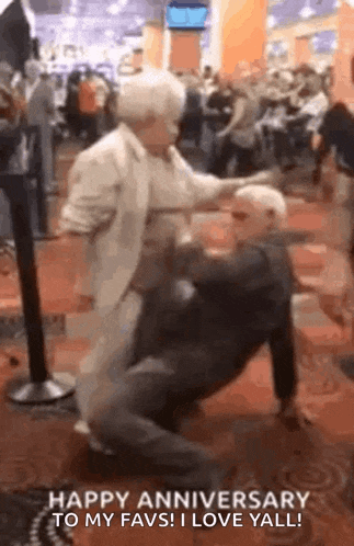 a man and a woman are dancing in a room .