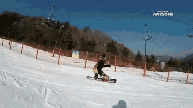 a snowboarder is doing a trick on a snowy slope with the words awesome above him