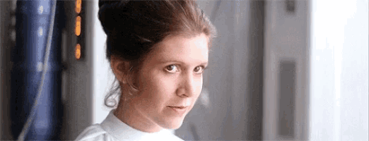 a close up of a woman 's face with a bun on her hair .