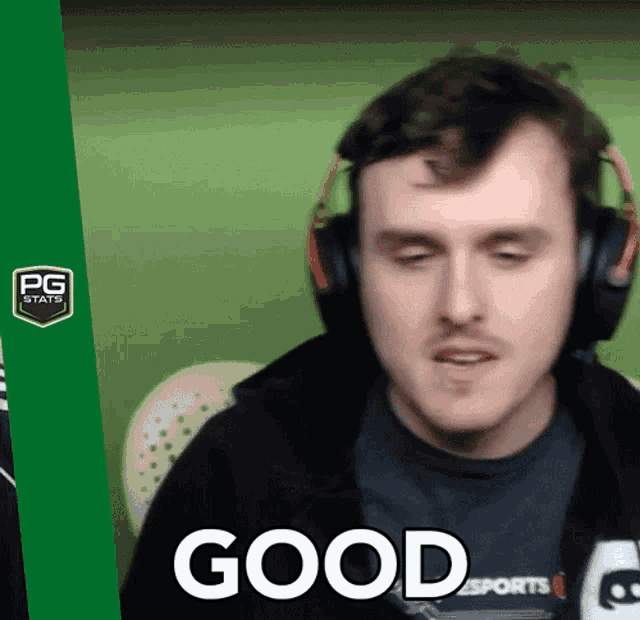 a man wearing headphones has the word good on his chest