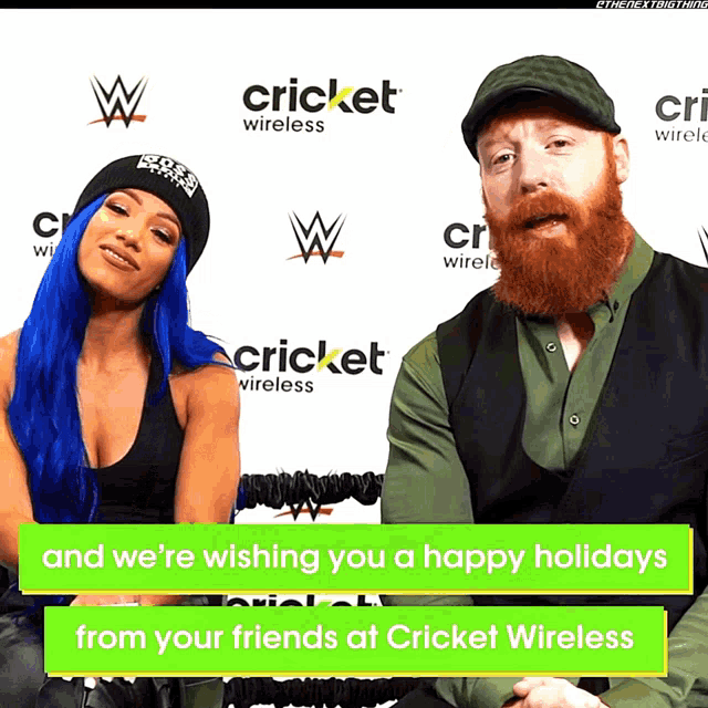 a man and woman are sitting in front of a cricket wireless sign