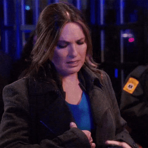 a woman in a gray jacket has a badge on her sleeve that says ' n.y.p.d. '