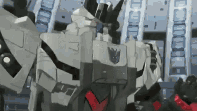 a transformer is standing in front of a building in a room .