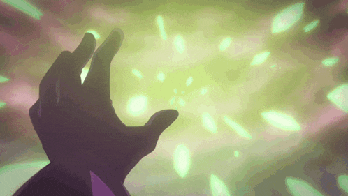 a person 's hand is reaching for a green light