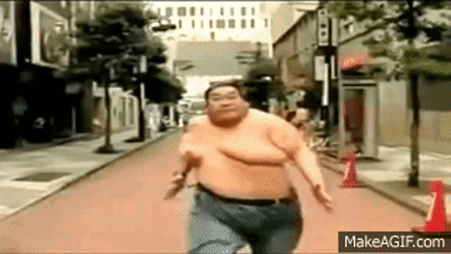 a very fat man is running down a city street .
