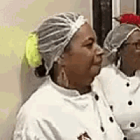 a woman in a chef 's hat is standing next to another woman .