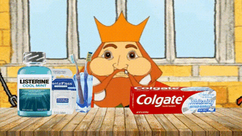 a box of colgate toothpaste sits on a table next to a listerine mouthwash