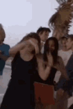 a blurry photo of a group of people standing on a beach