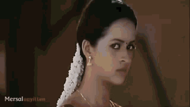 a close up of a woman 's face with the word mersal on the bottom left