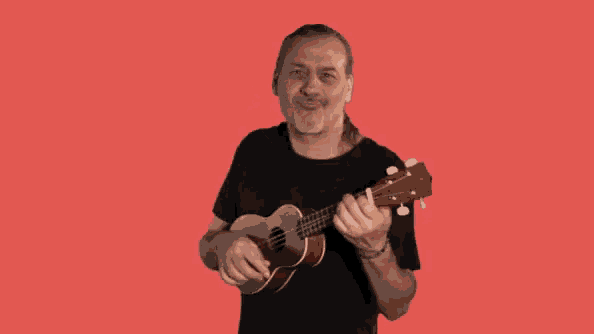 a man with long hair is playing an ukulele on a red background