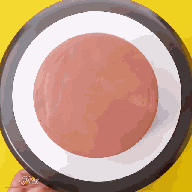 a black and white plate with a circle in the middle and the word plus on the bottom