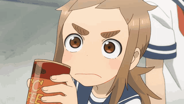 a girl is holding a can of coffee and making a face