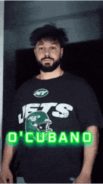 a man with a beard wearing a jets t-shirt