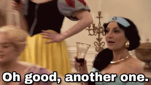 a woman in a princess costume is holding a glass of wine and says oh good , another one .