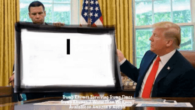 a man in a suit and tie holds up a sign that says i
