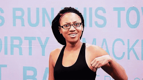 a woman wearing glasses and a sports bra is standing in front of a sign that says run this to dirty mack