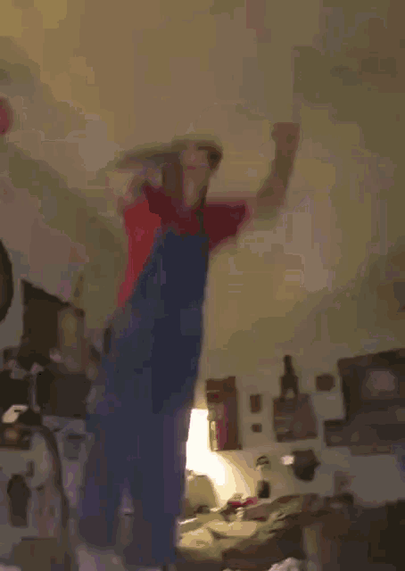 a man in a mario costume is jumping on a table