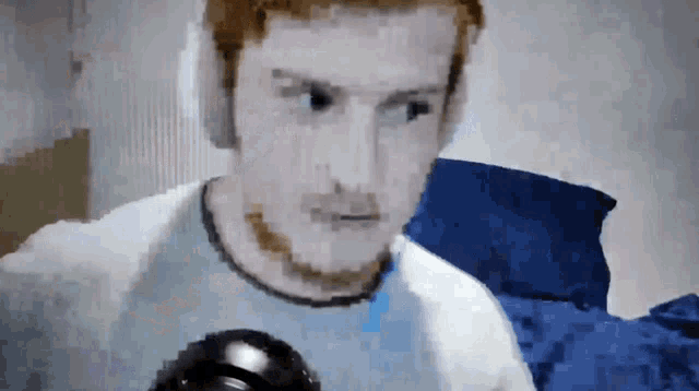 a pixelated image of a man 's face with headphones on