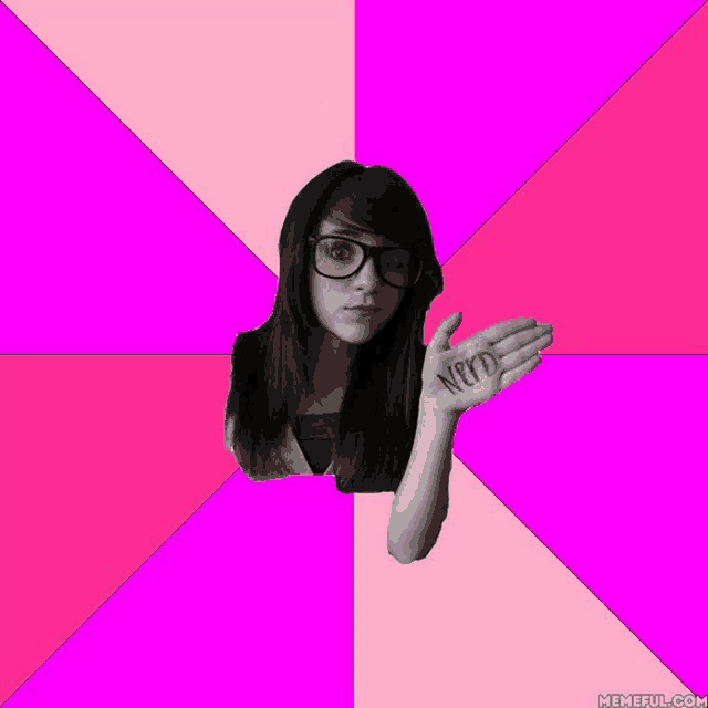 a girl wearing glasses holds up her hand with the word nerd written on it
