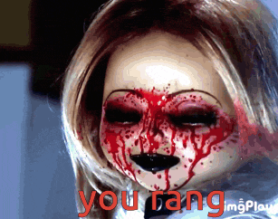 a creepy doll with blood on her face and the words you gang behind her