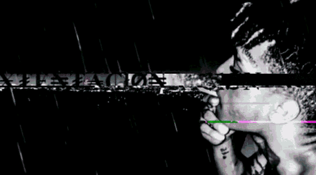 a man is singing into a microphone with the words xxxtentacion written above him