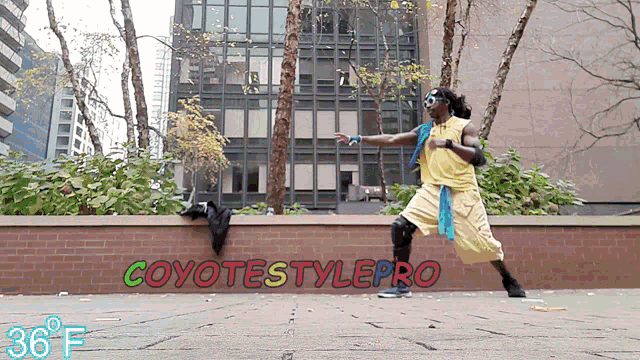 a man is dancing in front of a sign that says coyotestyle pro