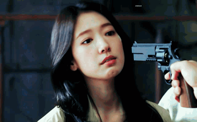 a close up of a woman holding a gun with a watermark that says ' amanda '