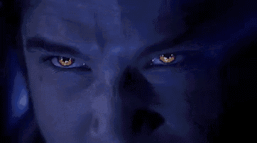 a close up of a man 's eyes with red eyes in a dark room .