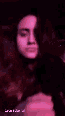 a woman is hugging another woman in a blurry photo .