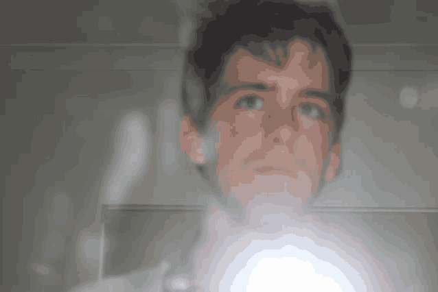 a man is taking a picture of himself with a flashlight