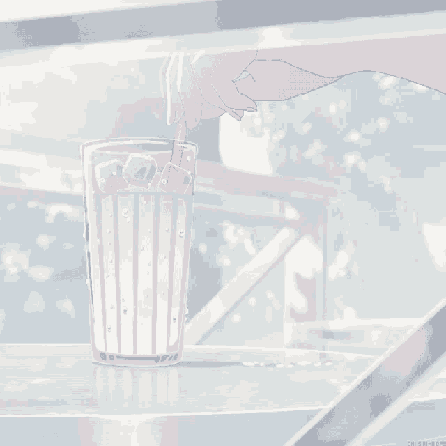 a glass of milk with a straw is on a table