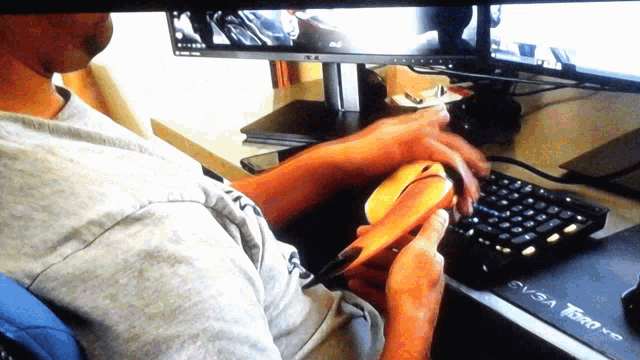 a man sitting at a desk with a keyboard and a mouse that says svsa