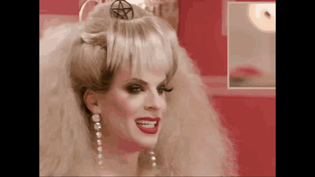 a woman with a pentagram on her head is smiling