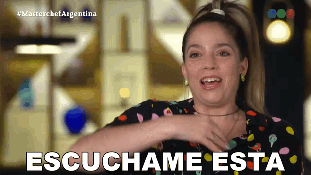 a woman in a polka dot shirt says escuchame esta in spanish