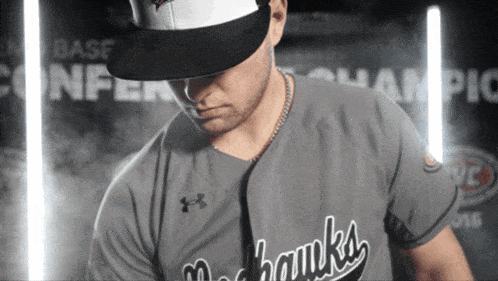 a man wearing an under armour shirt with the word hawks on the front