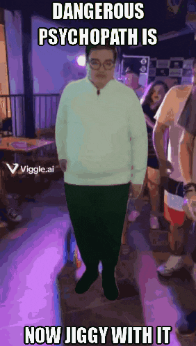 a man in a white sweater is standing in a crowd with the caption dangerous psychopath is now jiggy with it .