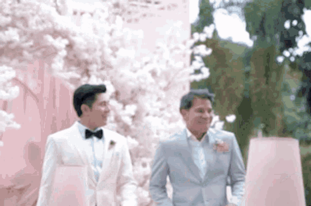 a bride and groom are walking down the aisle at a wedding ceremony .
