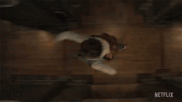 a person is falling down a set of stairs in a netflix advertisement