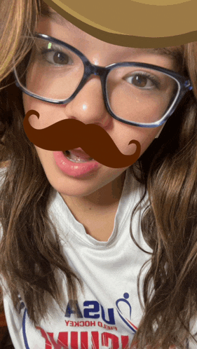 a girl wearing glasses and a fake mustache is wearing a world hockey shirt
