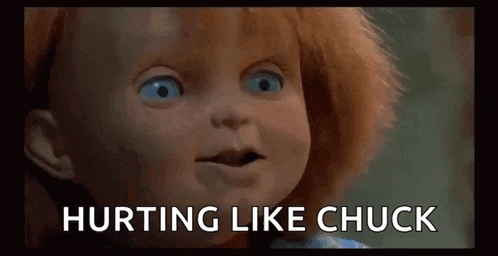 a close up of a doll with the words `` hurting like chuck '' written below it .