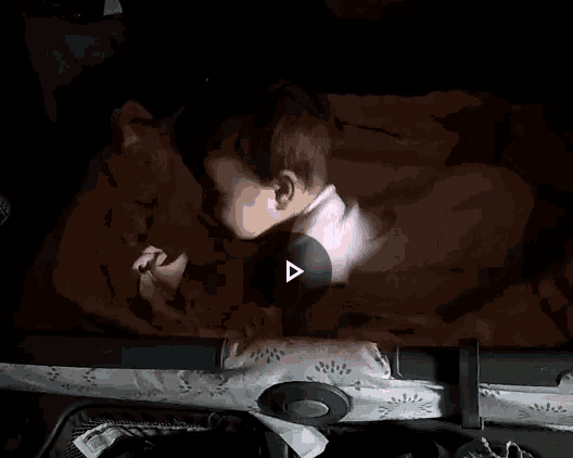 a baby is sleeping in a crib with a blanket on it