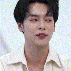 the man is wearing a white shirt and a necklace around his neck .