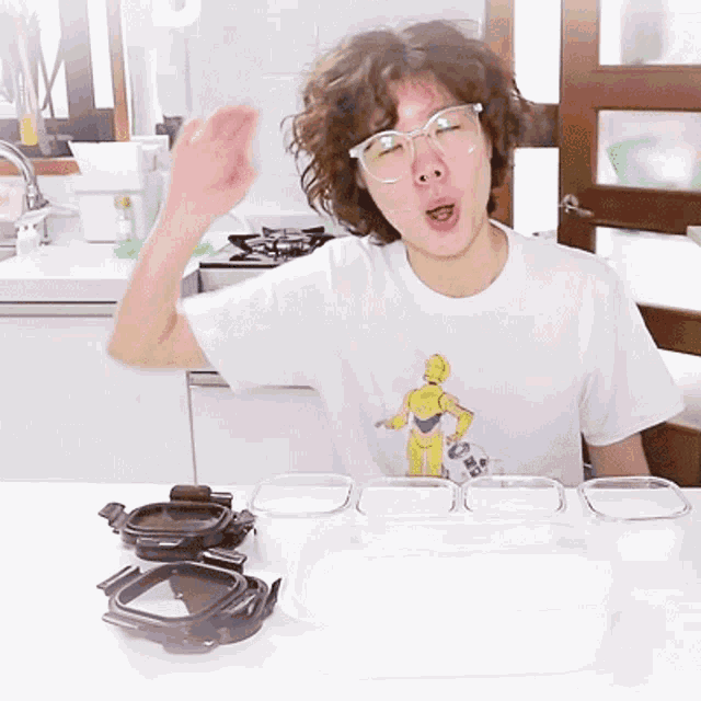 a woman wearing glasses and a t-shirt with a c-3po on it