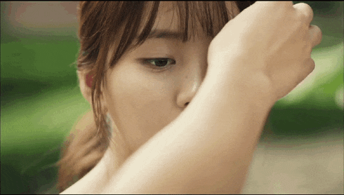 a woman covering her face with her hand in a close up