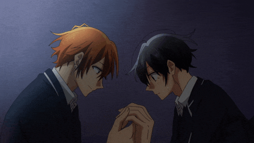 two anime characters are touching their hands in a dark room